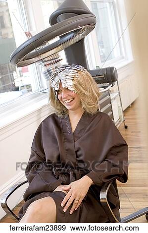 Blonde woman in her 30's having her hair colored in a salon View Large Photo Image Stock Photo - Blonde woman in her 30's having her hair colored in a salon. Fotosearch
