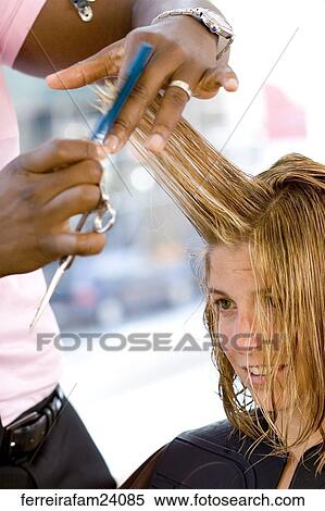 Blonde woman in her 30's having her hair cut in a salon View Large Photo Image Stock Photography - Blonde woman in her 30's having her hair cut in a salon. Fotosearch