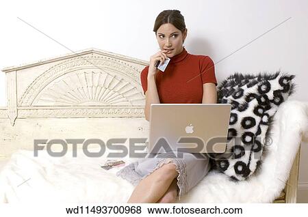 Stock Photo - Brunette female with hair in a pony tail. Fotosearch