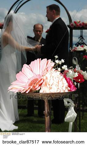 Couple being married on their wedding day, flowers, outside. View Large Photo Image Stock Photo - Couple being married on their wedding day, flowers, outside.. Fotosearch