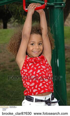 Ethnic little girl playing outside View Large Photo Image Stock Image - Ethnic little girl playing outside. Fotosearch