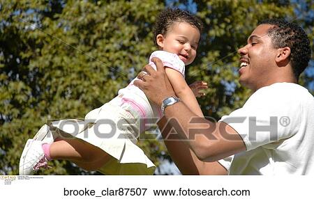 Father and daughter at the park playing laughing spring View Large Photo Image Stock Photo - Father and daughter at the park playing laughing spring. Fotosearch