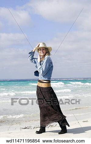 Picture - Female with long blonde hair wearing straw cowboy hat. Fotosearch
