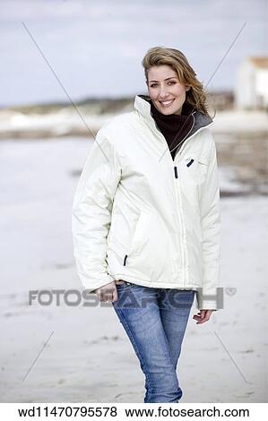 Female With Long Blonde Hair Wearing White Ski Jacket Skinny Blue