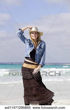 Stock Photography - Female with long blonde hair wearing straw cowboy hat. Fotosearch