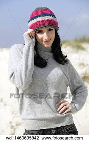 Female with long straight brunette hair wearing knitted hat View Large Photo Image Stock Image - Female with long straight brunette hair wearing knitted hat. Fotosearch