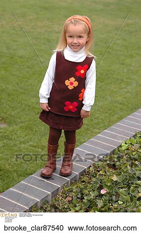 Little girl standing outside n her dress and boots View Large Photo Image Stock Image - Little girl standing outside n her dress and boots. Fotosearch