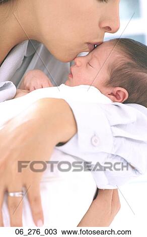 Mother and NewbornCropped shot of a woman cradling a sleeping baby in her arms View Large Photo Image Stock Image - Mother and NewbornCropped shot of a woman cradling a sleeping baby in her arms . Fotosearch