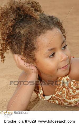 Portrait of a ethnic little girl with curly hair View Large Photo Image Stock Photo - Portrait of a ethnic little girl with curly hair. Fotosearch