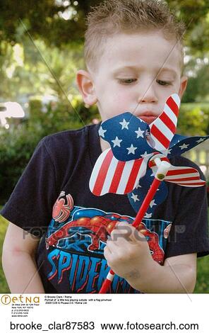Portrait of a little boy playing outside with a flag pinwheel View Large Photo Image Stock Image - Portrait of a little boy playing outside with a flag pinwheel. Fotosearch