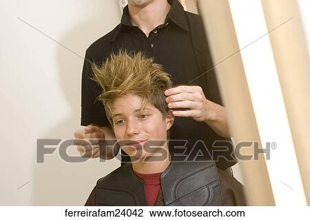 Portrait of a teenage boy having his hair styled in a salon. View Large Photo Image Stock Image - Portrait of a teenage boy having his hair styled in a salon.. Fotosearch