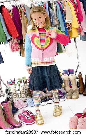 Portrait of a young girl posing with colorful clothing. View Large Photo Image Stock Photo - Portrait of a young girl posing with colorful clothing.. Fotosearch