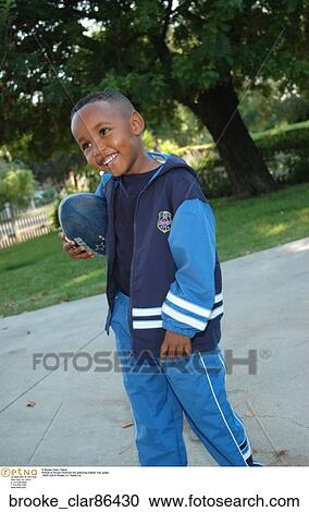 Stock Image - Portrait of African American boy gesturing outside". Fotosearch