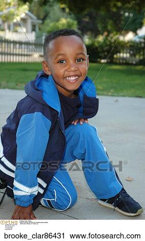 Stock Image - Portrait of African American boy outside smiling". Fotosearch