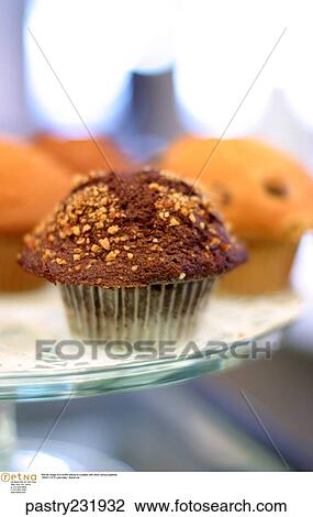 Still life image of a muffin sitting on a platter with other various pastries. View Large Photo Image Stock Image - Still life image of a muffin sitting on a platter with other various pastries.. Fotosearch