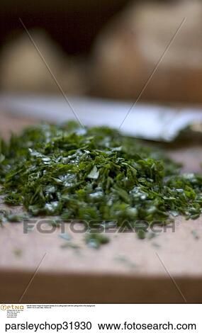 Still life indoor image of chopped parsley on a cutting board with the cutting knife in the background. View Large Photo Image Stock Image - Still life indoor image of chopped parsley on a cutting board with the cutting knife in the background.. Fotosearch