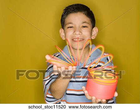 Stock images of science related topics Latin boy Student playing with a slinky View Large Photo Image Stock Image - Stock images of science related topics Latin boy Student playing with a slinky. Fotosearch