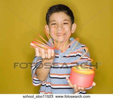 Stock images of science related topics Latin boy Student playing with a slinky View Large Photo Image Stock Image - Stock images of science related topics Latin boy Student playing with a slinky. Fotosearch