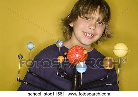 Stock images of science related topics boy student wearing an blue shirt showing off his solar system school project. View Large Photo Image Stock Image - Stock images of science related topics boy student wearing an blue shirt showing off his solar system school project.. Fotosearch