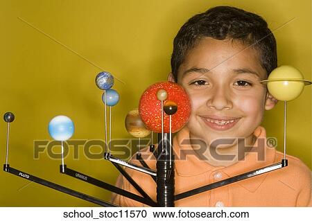Stock images of science related topics latin boy student wearing an orange shirt showing off his solar system school project. View Large Photo Image Stock Image - Stock images of science related topics latin boy student wearing an orange shirt showing off his solar system school project.. Fotosearch