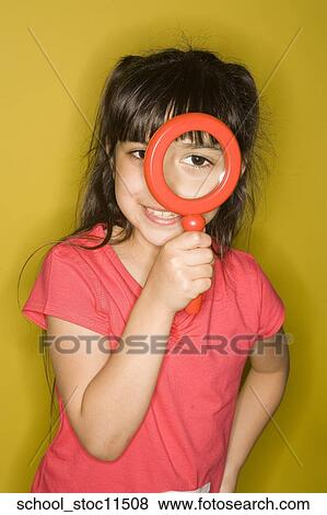 Stock images of science related topics Girl Student peers through a magnifying glass. she's wearing a pink shirt and has her hair pulled into pigtails. View Large Photo Image Stock Photo - Stock images of science related topics Girl Student peers through a magnifying glass. she's wearing a pink shirt and has her hair pulled into pigtails.. Fotosearch