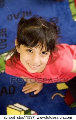 Stock images of science related topics Girl student wearing a pink shirt and sitting in the libray View Large Photo Image Stock Photo - Stock images of science related topics Girl student wearing a pink shirt and sitting in the libray. Fotosearch