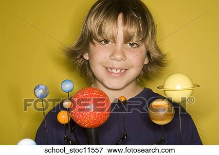 Stock images of science related topics boy student wearing an blue shirt showing off his solar system school project. View Large Photo Image Stock Photo - Stock images of science related topics boy student wearing an blue shirt showing off his solar system school project.. Fotosearch