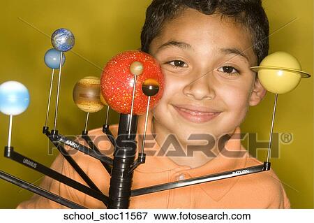 Stock images of science related topics latin boy student wearing an orange shirt showing off his solar system school project. View Large Photo Image Stock Photo - Stock images of science related topics latin boy student wearing an orange shirt showing off his solar system school project.. Fotosearch