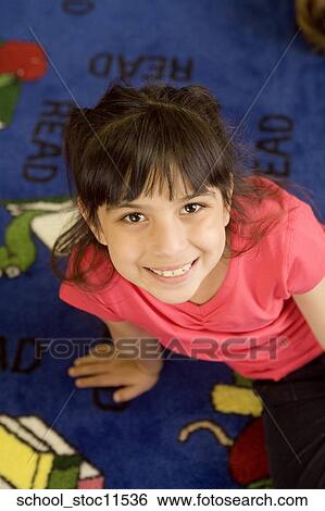 Stock images of science related topics Girl student wearing a pink shirt and sitting in the libray View Large Photo Image Stock Photograph - Stock images of science related topics Girl student wearing a pink shirt and sitting in the libray. Fotosearch