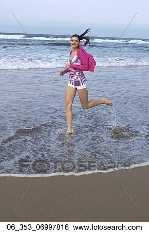 Summer BeautyWoman wearing a stripey vest top cardigan and white hotpants shorts running on the beach View Large Photo Image Stock Photograph - Summer BeautyWoman wearing a stripey vest top cardigan and white hotpants shorts running on the beach . Fotosearch
