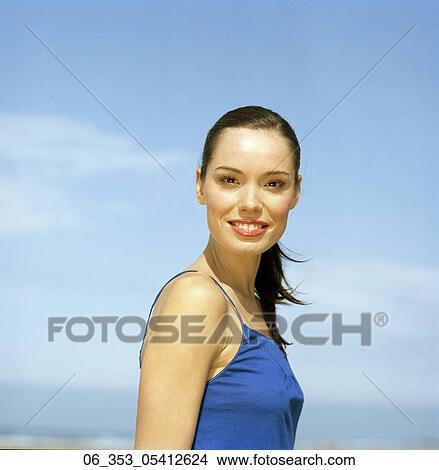 Woman BeachWoman standing on a beach wearing a blue vest View Large Photo Image Picture - Woman BeachWoman standing on a beach wearing a blue vest . Fotosearch