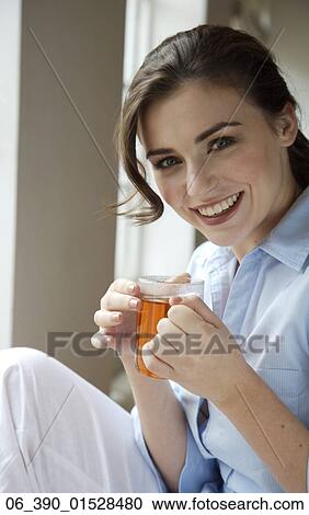 Woman DrinkingCropped shot of a woman wearing a blue shirt drinking from a glass mug View Large Photo Image Stock Image - Woman DrinkingCropped shot of a woman wearing a blue shirt drinking from a glass mug. Fotosearch