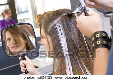 Woman in her 30's having her hair highlighted in a salon View Large Photo Image Stock Image - Woman in her 30's having her hair highlighted in a salon. Fotosearch