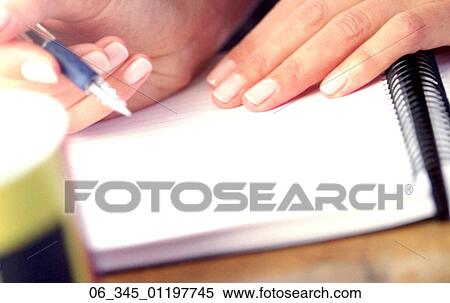 Stock Photography - Woman WritingWoman writing in a notepad . Fotosearch