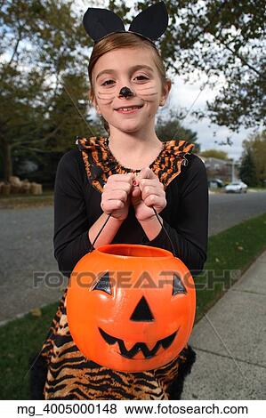A, jeune fille, sur, les, trottoir, sur, les, recherche, pour, plus, halloween, candy., elle, est, habillé, comme, a, chat, dans, a, noir, unitard, et,