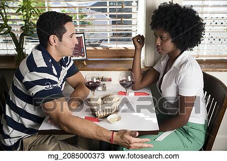 A young couple in their 20's enjoy a meal together in a restaurant. September 1, 2006. © RD / Retna Digital View Large Photo Image Stock Image - A young couple in their 20's enjoy a meal together in a restaurant. September 1, 2006. © RD / Retna Digital. Fotosearch