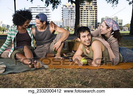 Four friends in their 20's relax while and eating a snack in the park. September 1, 2006 credit - RD / Retna Digital View Large Photo Image Stock Image - Four friends in their 20's relax while and eating a snack in the park. September 1, 2006 credit - RD / Retna Digital. Fotosearch