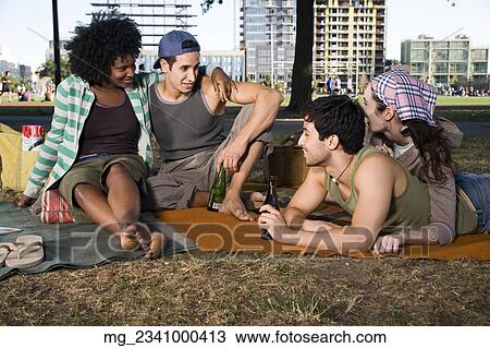 Four friends in their 20's relax while and eating a snack in the park. September 1, 2006 credit - RD / Retna Digital View Large Photo Image Stock Image - Four friends in their 20's relax while and eating a snack in the park. September 1, 2006 credit - RD / Retna Digital. Fotosearch