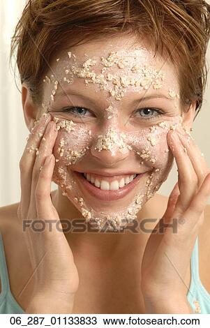 Front view head and shoulders young woman with short hair applying a face mask View Large Photo Image Stock Image - Front view head and shoulders young woman with short hair applying a face mask . Fotosearch