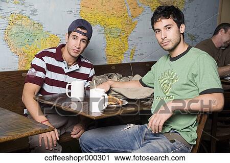 Two friends enjoy a drink at a coffee shop. December 30, 2006 credit - RD / Retna Digital View Large Photo Image Stock Image - Two friends enjoy a drink at a coffee shop. December 30, 2006 credit - RD / Retna Digital. Fotosearch