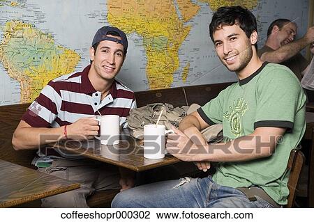 Two friends enjoy a drink at a coffee shop. December 30, 2006 credit - RD / Retna Digital View Large Photo Image Stock Image - Two friends enjoy a drink at a coffee shop. December 30, 2006 credit - RD / Retna Digital. Fotosearch