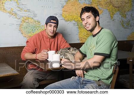Stock Image - Two friends enjoy a drink at a coffee shop. December 30, 2006 credit - RD / Retna Digital. Fotosearch