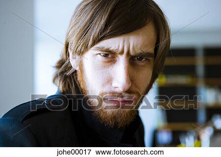Stock Photo - beard, redheaded, portrait, frontal, face, grimace, astute. Fotosearch