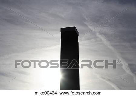 Picture - chimney, tower, back light, sky, contour, sun, clouds. Fotosearch
