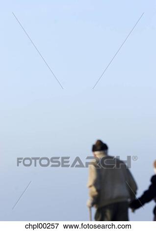 Stock Photo - edge of the screen, senior, blurred, old, cap, back view. Fotosearch