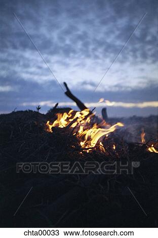Stock Image - fire, camping, campfire, field, wideness, wilderness, nature. Fotosearch