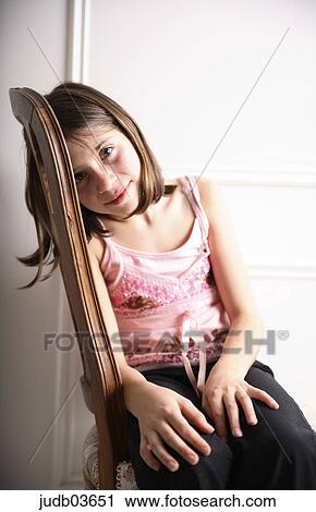 Stock Image - girl, brown hair, dark hair, Kind, child, chair, torso. Fotosearch
