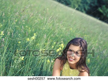 Stock Photo - human, person, woman, recreation, meadow, grass. Fotosearch