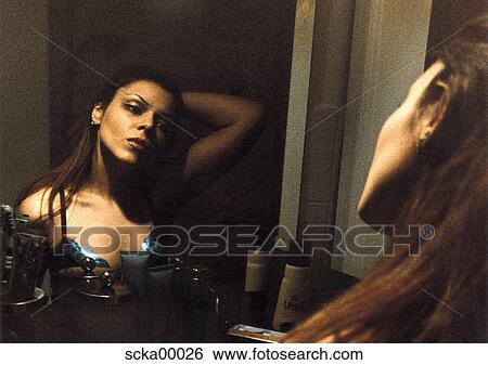 Stock Photograph - human, woman, long hair, brown hair, mirror, bathroom. Fotosearch