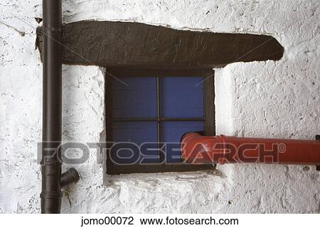 Stock Image - mullion and transom, cellar window, redly, red, ruddy, commie, black. Fotosearch